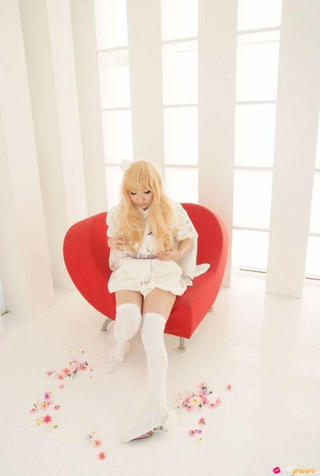 all gravure: Blond japanese girl Saku wears white stockings while modelling on a sofa