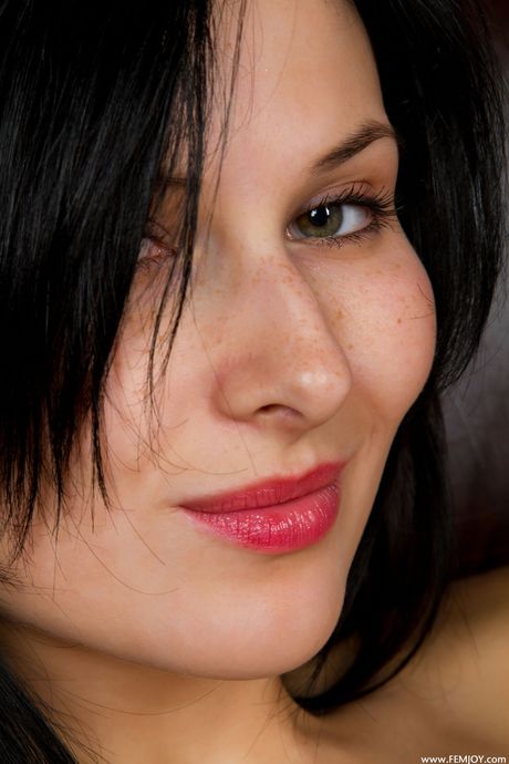 femjoy: Dark haired teen Kelly F strips down on a bed without shyness