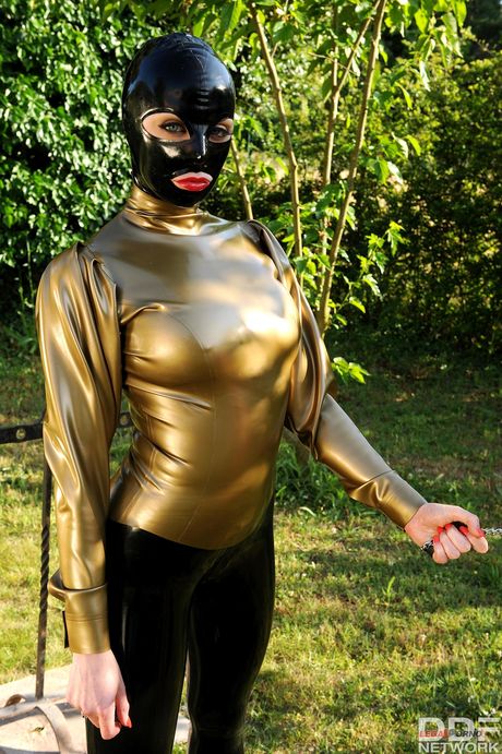 BDSM fetish scene with latex-clad lesbians and a naked submissive BDSM fetish scene with latex-clad lesbians and a naked submissive